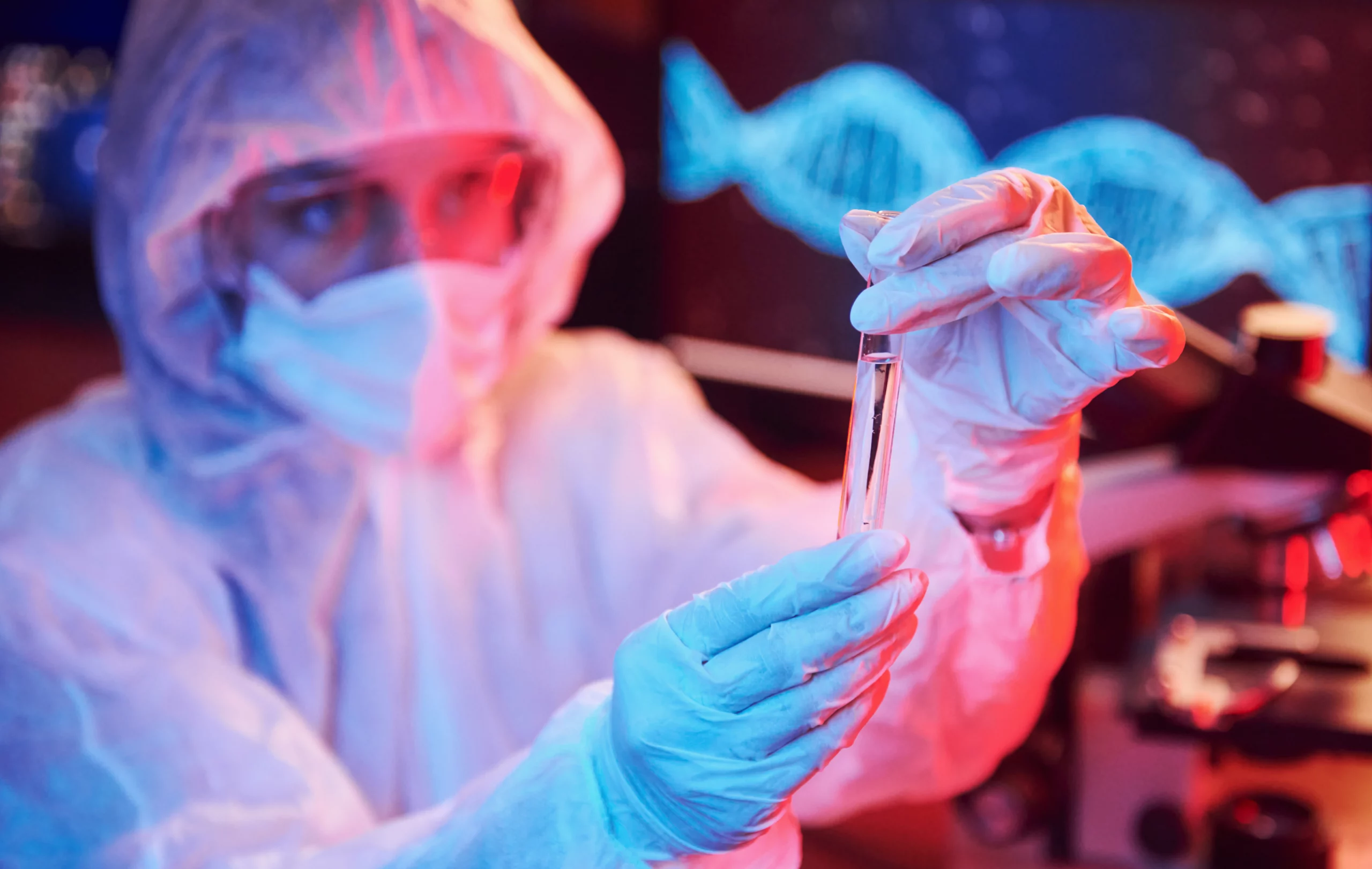 Scientist in protective gear examining DNA sample with helix graphic.