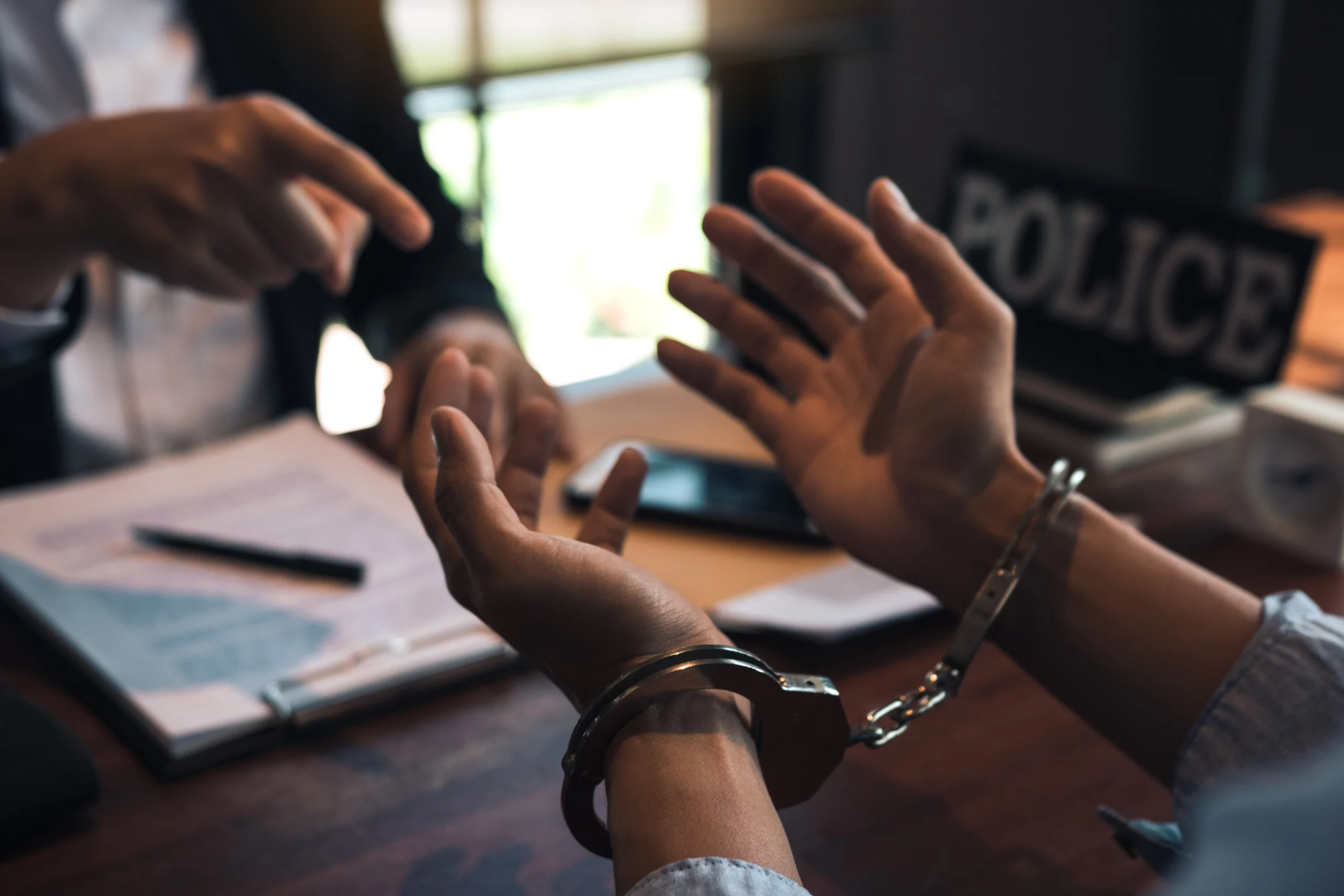 Handcuffed suspect facing legal confrontation during police interrogation in Indiana felony case