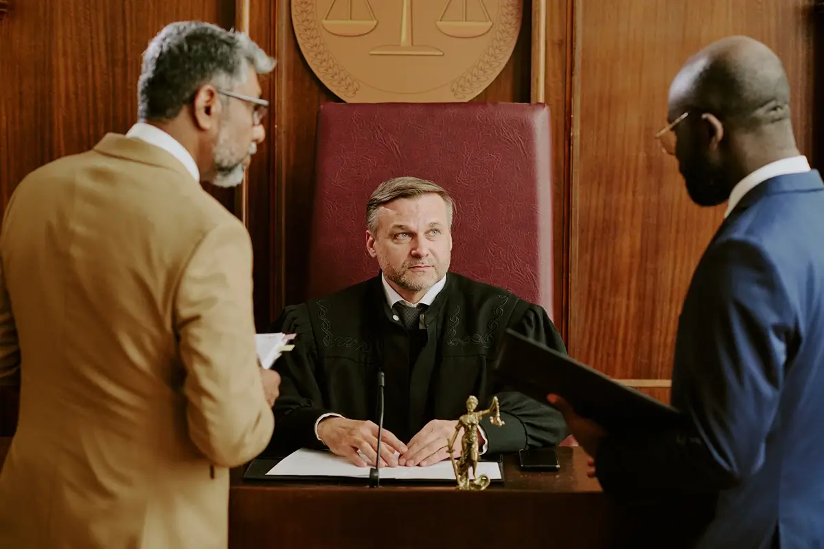 lawyers talking to judge in courtroom setting